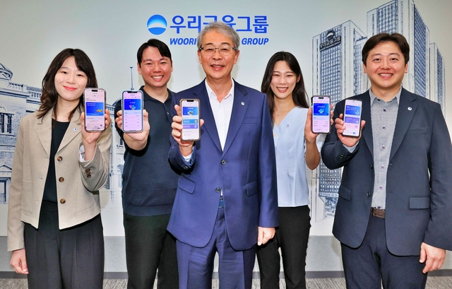 임종룡(가운데) 우리금융그룹 회장이 지난 6일 유니버설뱅킹 신규 가입자 100만명 돌파를 기념해 직원들과 사진을 촬영하고 있다.  [우리금융 제공]