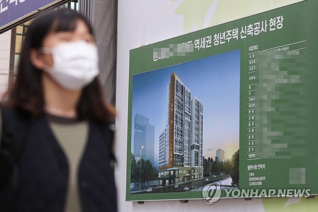 한 시민이 서울 역세권청년주택 신축공사 현장 앞을 지나가고 있다. [연합뉴스 자료사진]