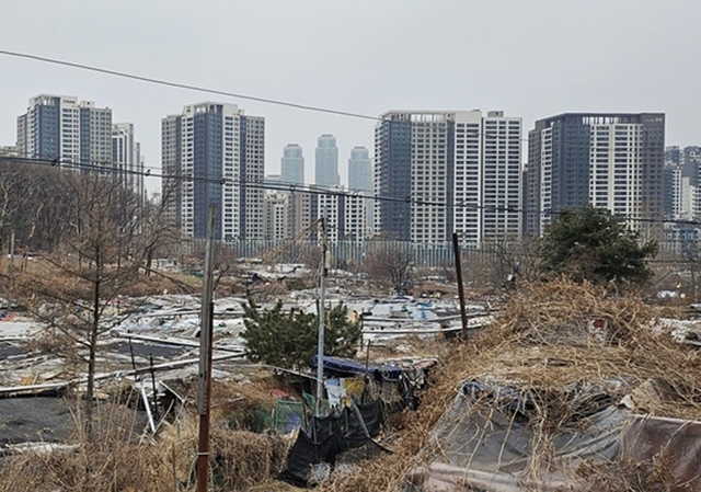 구룡마을 건너편으로 새 아파트가 들어서 있다. [박상길 기자]