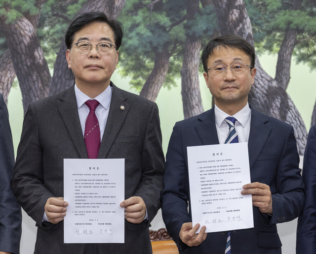 4일 국회에서 여야 원내지도부는 협상 끝에 대미투자특별법 특위 구성에 합의해 합의문에 서명한 뒤 양당 원내대표가 공개하고 있다. (왼쪽부터) 국민의힘 송언석 원내대표, 더불어민주당 한병도 원내대표. [연합뉴스]
