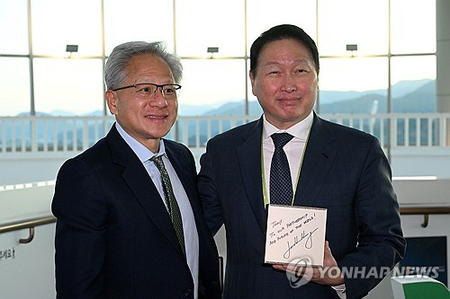 젠슨 황 엔비디아 CEO가 2025년10월31일 경북 경주 예술의전당에서 열린 아시아태평양경제협력체(APEC) 최고경영자(CEO) 서밋에 참석해 최태원 대한상의 회장과 만나 AI슈퍼컴퓨터 ‘DGX스파크’를 선물하고 있다.   [연합뉴스]