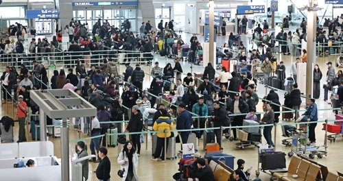 설 연휴를 앞둔 13일 인천국제공항 제1여객터미널 출국장에서 이용객들이 탑승수속을 위해 줄을 서고 있다. [영종도=연합뉴스]