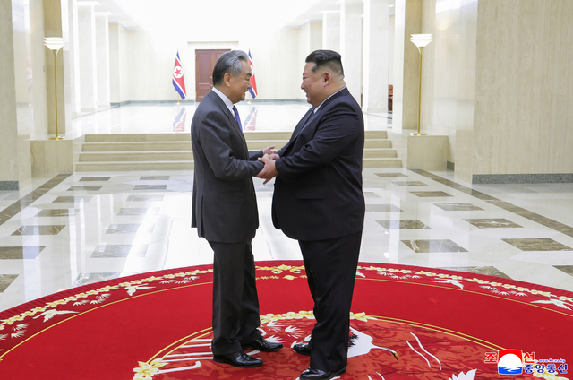 김정은 북한 국무위원장(오른쪽)이 지난 10일 북한을 방문한 왕이 중국공산당 중앙정치국 위원 겸 외교부장(왼쪽)과 악수를 나누고 있다. 연합뉴스