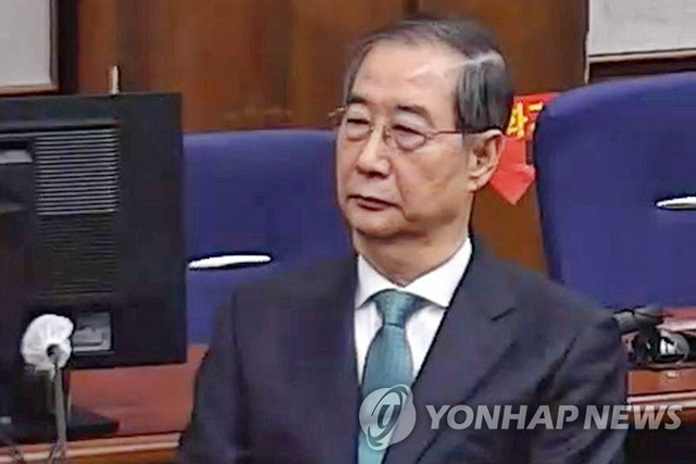 한덕수 전 국무총리(왼쪽)가 21일 서울중앙지법에서 열린 1심 선고 공판에 출석한 모습. 연합뉴스