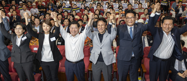 12일 국회 의원회관에서 열린 전국자치분권민주지도자회의(KLDC)에 더불어민주당 당 대표 후보 주자들과 자치분권회의 상임대표인 박승원 광명시장이 손을 들어 인사하고 있다. (오른쪽 부터) 정청래 전 대표, 송영길 의원, 김민석 전 총리, 박승원 광명시장, 고민정 의원, 김보미 전 강진군 의원.