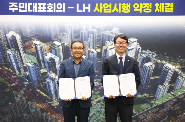 LH 경기남부지역본부에서 5일 강오순(오른쪽) LH 지역균형본부장과 백종철 군포 산본 11구역 주민대표회의 위원장이 기념사진을 촬영하고 있다. [LH 제공]