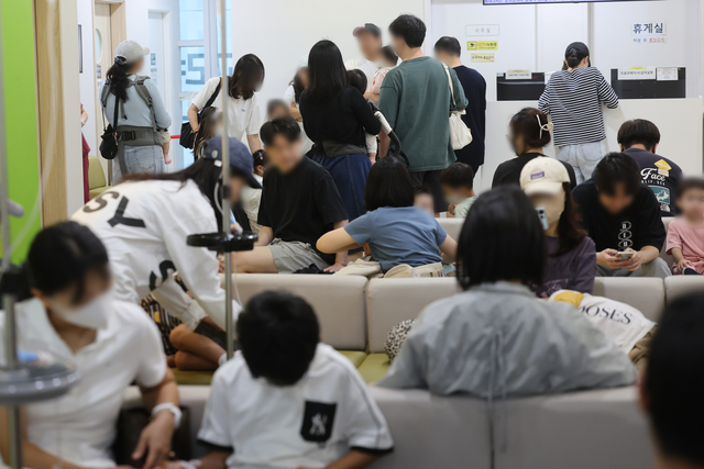 독감이 유행 중인 13일 서울 성북구의 한 소아청소년과 전문병원이 환자와 보호자로 붐비고 있다. [연합뉴스]